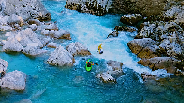 istock Kayakers navigate through a rocky, fast-flowing river, showcasing thrilling whitewater kayaking 2225690485