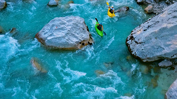 istock Kayakers navigate through rapids, tackling challenging currents and rocks in an extreme adventure 2225698264