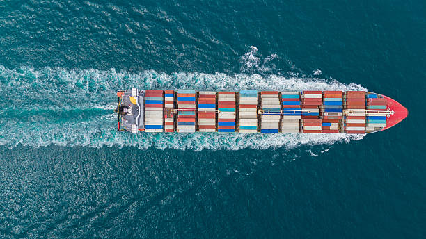 istock Tow view  Cargo Container ship the ocean ship carrying container and running for import export concept technology freight shipping by ship. Container Vessel running out from international customs. 2225704869