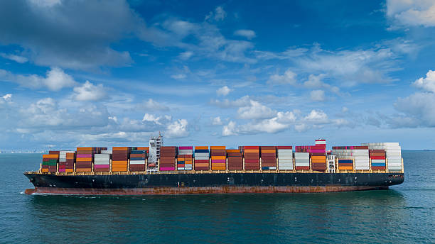 istock Side Cargo Container ship the ocean ship carrying container and running for import export concept technology freight shipping by ship. Container Vessel running out from international customs. 2225705504