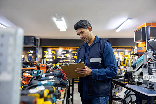 istock Employee working at a hardware store taking inventory on a clipboard 2225706053