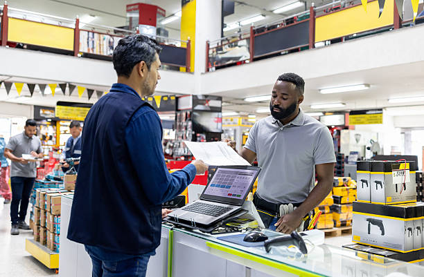 istock Customer receiving an invoice while buying tools at a hardware store 2225706097