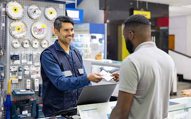 istock Retail clerk giving his receipt to a customer while shopping at a hardware store 2225706124