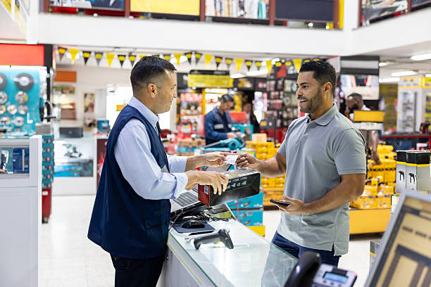 istock Man receiving his receipt after buying tools at a hardware store 2225706142
