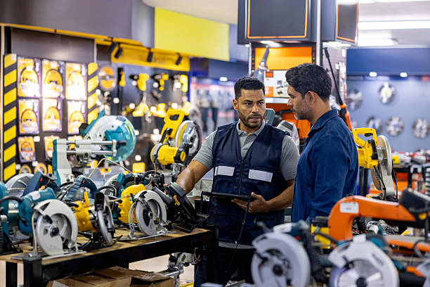istock Retail clerk helping a man buying a circular saw at a hardware 2225706158