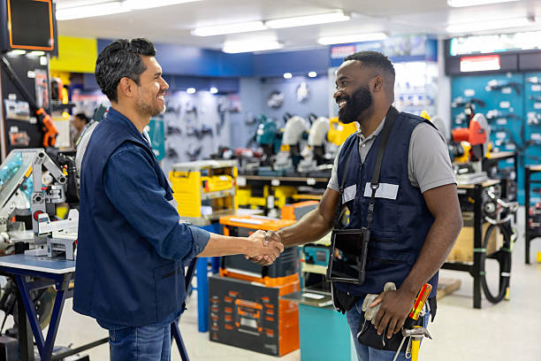 istock Customer greeting a retail clerk with a handshake while shopping at the hardware store 2225706171