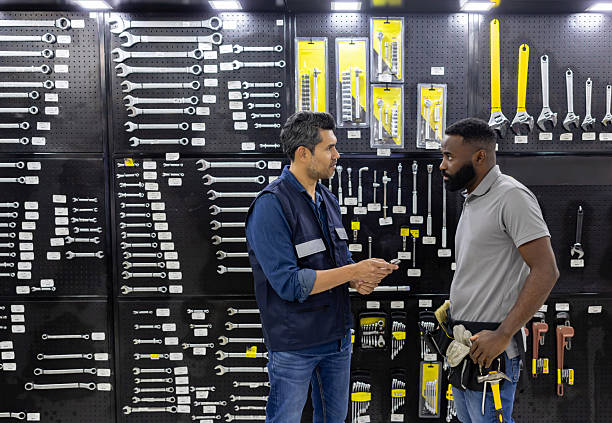 istock Retail clerk assisting a customer buying a wrench at a hardware store 2225709504