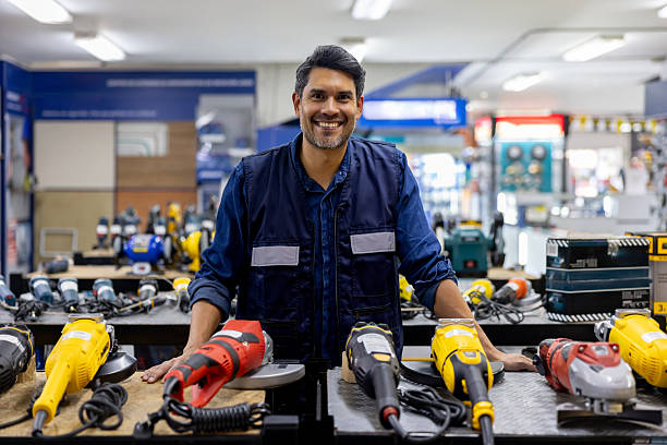 istock Happy retail clerk working at a hardware store selling tools and smiling 2225709545
