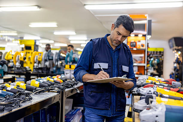 istock Retail clerk working at a hardware store and taking inventory using a clipboard 2225709557