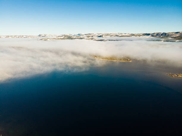 Aerial view. Hardangervidda mountain plateau, Norway landscape. Morning time, clouds over lake water. National tourist Hardangervidda route.