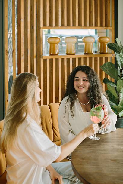 istock Two young women toasting cocktails in a cafe 2225731932