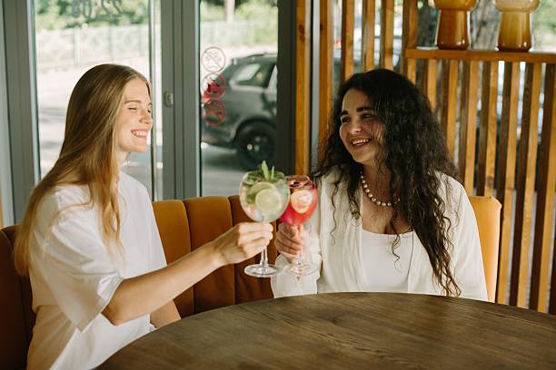 istock Two young women toasting cocktails in a cafe 2225731967