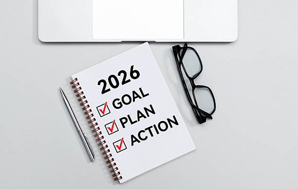 istock 2026 goal, plan, action checklist text on note pad with eyeglasses pen and laptop 2225733301