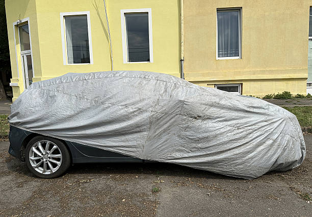 istock Covered car on the city street 2225734691
