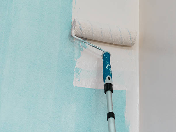 istock Person applying paint on wall 2225734888