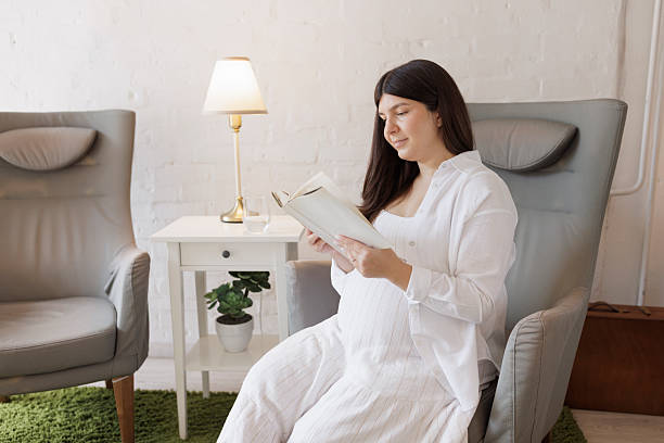 istock Pregnant young woman,  reading a book. 2225737432