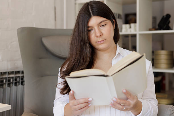 istock Pregnant young woman,  reading a book. 2225737469