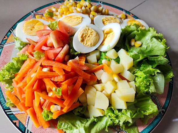 istock extra-large, healthy salad for her husband's lunch. 2225741045