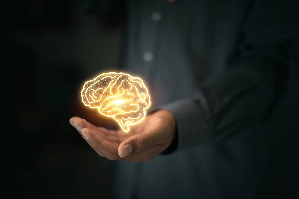 istock Human hand holding glowing digital brain with technology concept and idea icons 2225741631