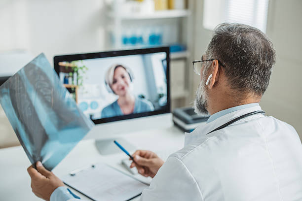 istock Doctor meeting remotely with his patient 2225745558