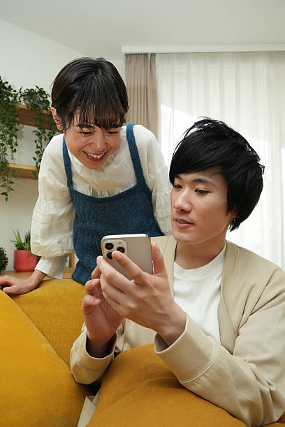 istock Couple,using,smartphones,on,the,sofa 2225748115