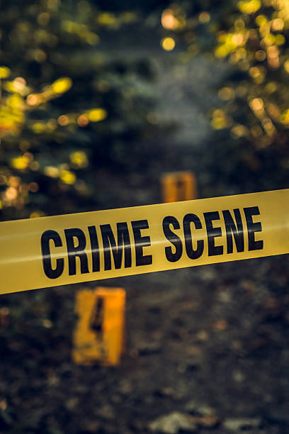 istock Crime scene  tape in forest area 2225749545