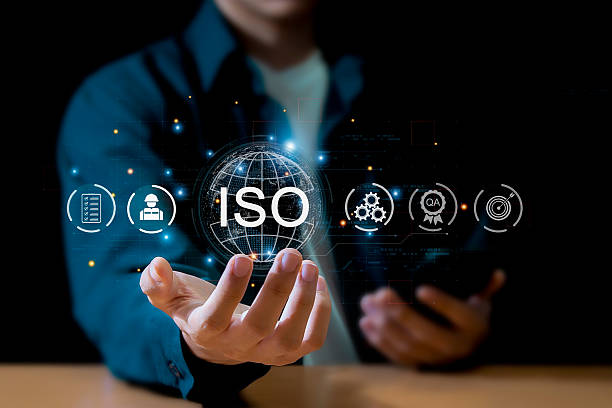 istock Businessman ISO symbol showing quality assurance on virtual screen 2225749867