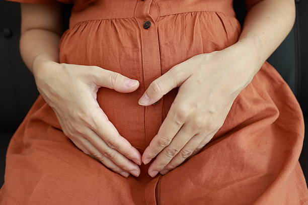 istock Pregnant woman's belly with hands 2225751370