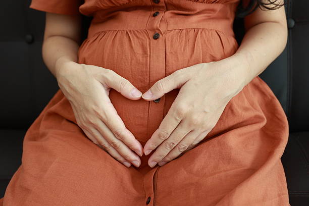 istock Pregnant woman's belly with hands 2225751405