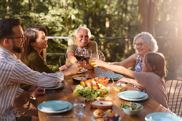 istock Happy extended family toasting during lunch on a terrace. 2225755292
