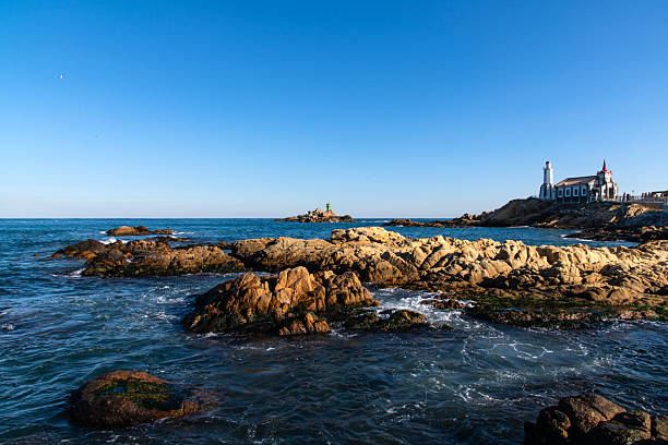 istock church and beacon on the rock at the seaside 2225755320