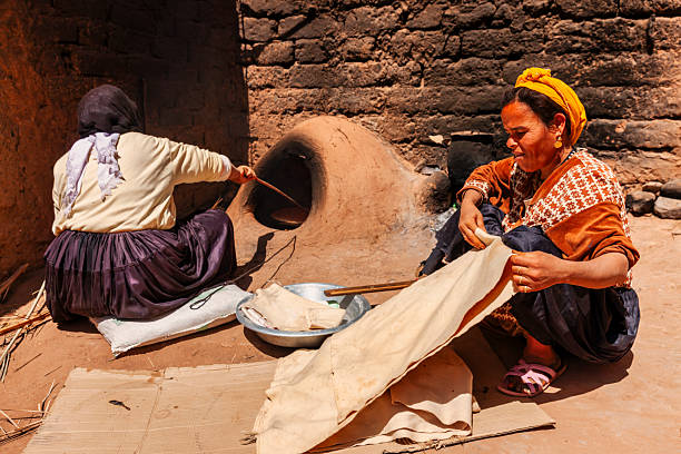 istock Moroccan women baking bread - khubz 2225755342