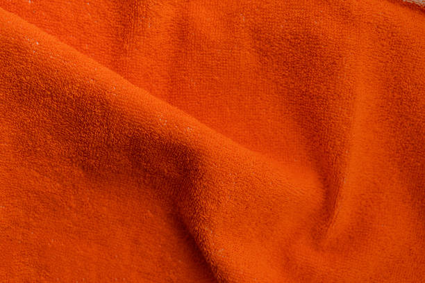 istock Orange towel on white background, soft bath textile or beach accessory, top view 2225755518