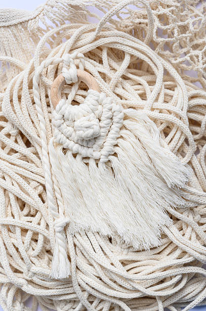 istock Macrame Keychain Elegance: A close-up of a meticulously crafted macrame keychain with , highlighting the intricate woven design and natural textures. 2225756096