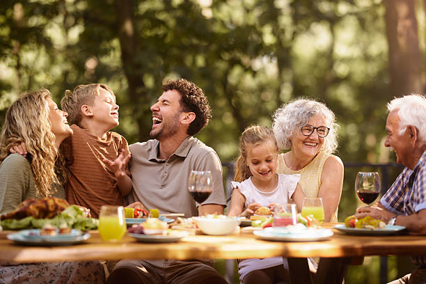 istock Cheerful extended family having fun during lunch at picnic table. 2225757315