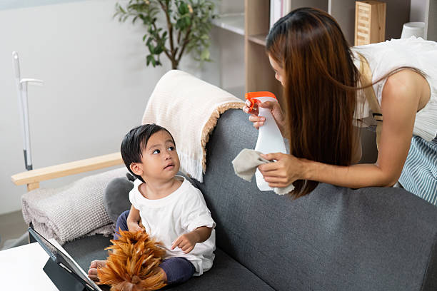 istock Mother Cleaning While Child Engages in Playful Learning 2225759955