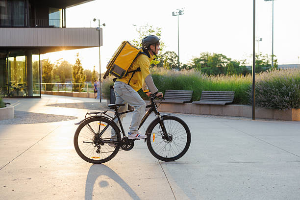 istock Bicycle courier delivering goods on a sunny day in an urban area 2225760066