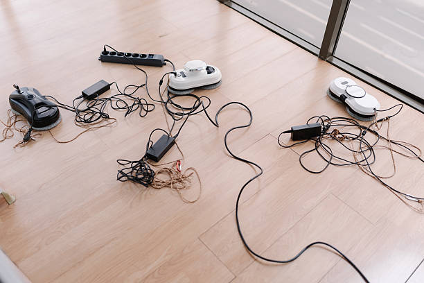istock Several window cleaning robots lying on floor, connected to chargers and power strip, prepared for upcoming cleaning tasks at home. 2225760984