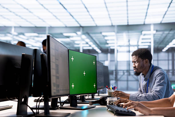 istock Man in data center updating systems on green screen PC to protect servers 2225767335