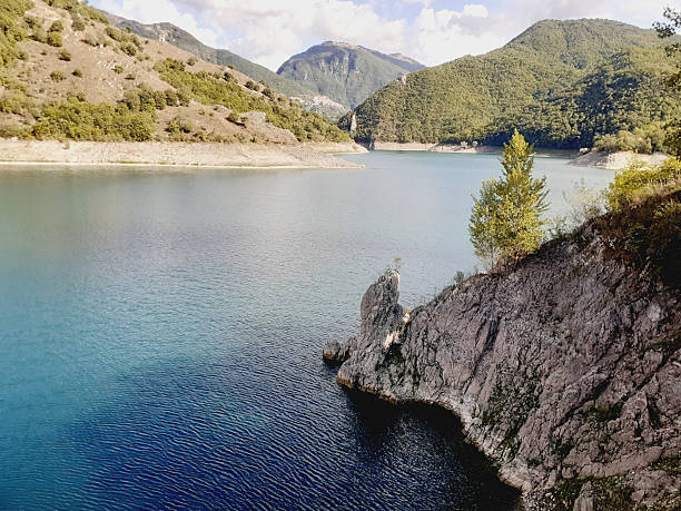 istock Turano Lake, lake view with lone tree and verdant mountain backdrop 2225767414