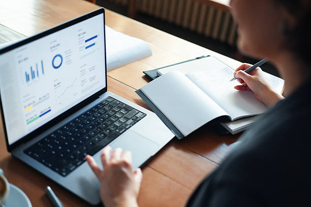 istock Businesswoman Working on Data Analysis with Laptop and Notebook at Office 2225770299