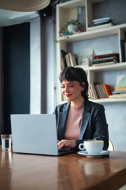istock Professional Woman Working on Laptop in a Modern Office Environment 2225770303