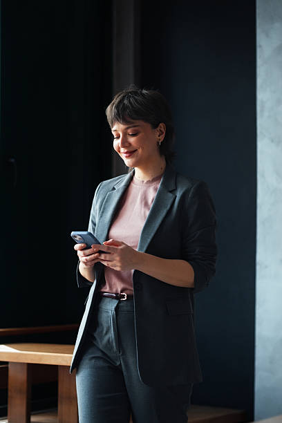 istock Professional Woman Using Smartphone in a Stylish Modern Office Setting 2225770420