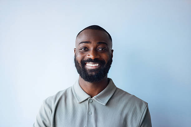 istock Confident Man Smiling Against Light Blue Background in Casual Shirt 2225770902