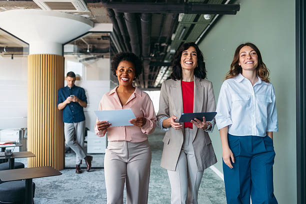 istock Smiling Business Professionals Collaborating in Modern Office Environment 2225770915