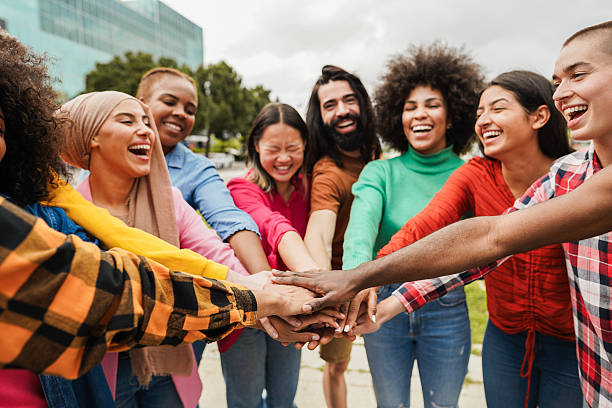 istock Young multiracial people having fun stacking hands outdoor - Diversity and joyful lifestyle concept - Soft focus on african hand 2225772506