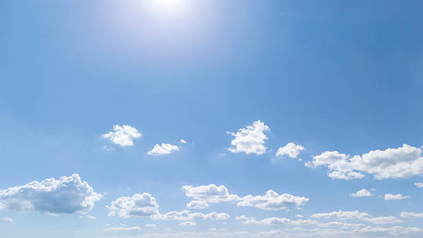 istock Vast blue sky with fluffy white clouds illuminated by bright sunlight. A serene atmosphere ideal for depicting nature and tranquility during daytime. 2225780315