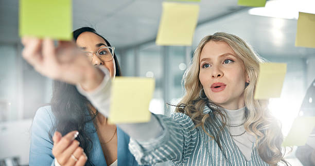 istock Team, glass and business people brainstorming on sticky notes with project ideas, schedule and agenda. Collaboration, problem solving and coworkers with discussion in planning meeting in workplace 2225780684