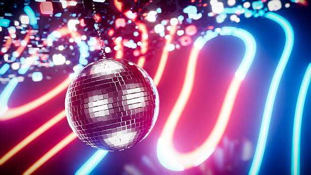 istock Shiny disco ball hanging with colorful neon lights reflecting on background 2225781062