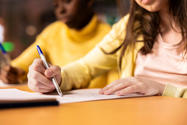 istock Two girls scholars preparing for classes and writing notes in textbooks 2225781692